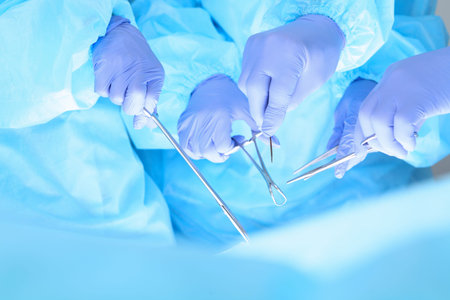 Close-up of unknown surgeons at work while operating at hospital. Health care and veterinary conceptの写真素材