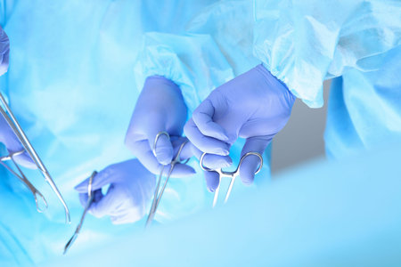 Close-up of unknown surgeons at work while operating at hospital. Health care and veterinary concept