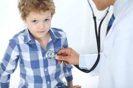 Doctor and child patient. Physician examines little boy by stethoscope. Medicine and childrens therapy conceptの写真素材