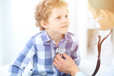 Doctor and child patient. Physician examines little boy by stethoscope. Medicine and childrens therapy conceptの写真素材