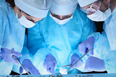 Group of surgeons at work while operating at hospital. Health care and veterinary conceptの写真素材