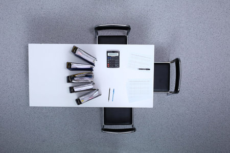 Binders with papers are waiting to be processed with bookkeeper. Internal Revenue Service inspector working place. View from aboveの写真素材