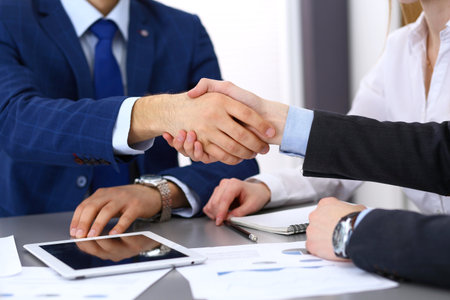 Business people shaking hands, finishing up a papers signing. Meeting, agreement and lawyer consulting conceptの写真素材