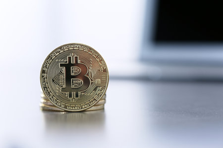 Golden Bitcoin in sharp focus, closeupの写真素材