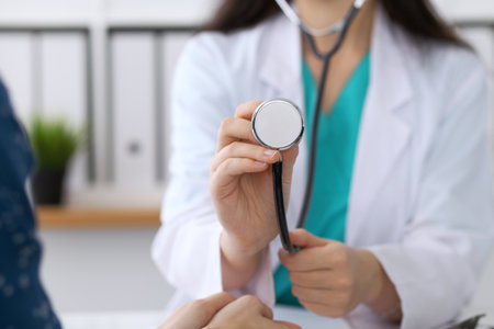 Doctor with a stethoscope in the hand. Physician  is ready to examine her female patient.の写真素材