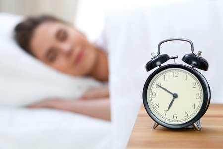Beautiful young woman sleeping while lying in bed comfortably and blissfullyの写真素材