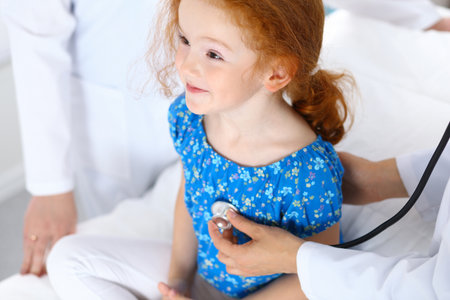 Doctor examining a little girl with stethoscope.Medicine and healthcare conceptの写真素材