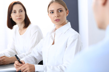 Group of business people or lawyers discussing  terms of transaction in office. Meeting and teamwork conceptの写真素材