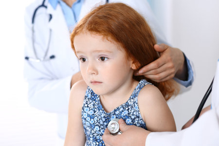 Doctor examining a little girl with stethoscope.Medicine and healthcare conceptの写真素材
