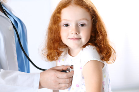 Doctor examining a little girl with stethoscope.Medicine and healthcare conceptの写真素材