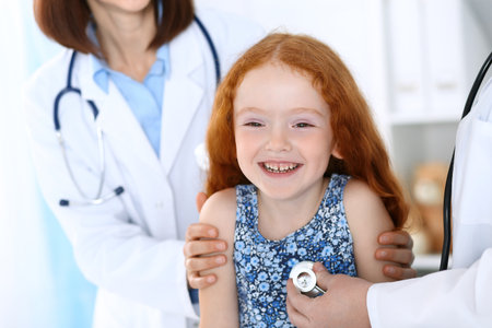 Doctor examining a little girl with stethoscope.Medicine and healthcare conceptの写真素材