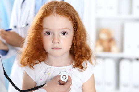 Doctor examining a little girl with stethoscope.Medicine and healthcare conceptの写真素材