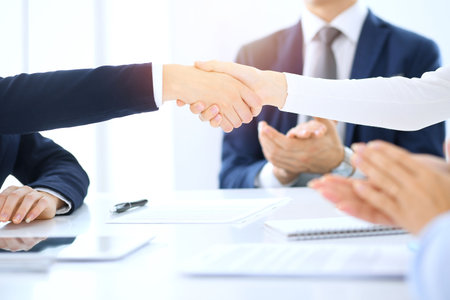Group of business people or lawyers shaking hands finishing up a meeting , close-up. Success at negotiation and handshake conceptsの写真素材