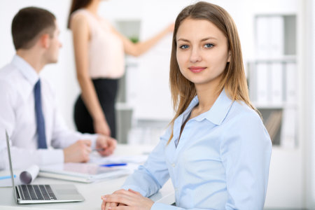 Portrait of a young business woman  at meeting. Negotiation conceptの写真素材