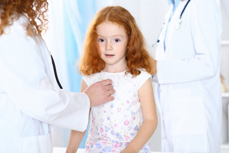 Doctor examining a little girl with stethoscope.Medicine and healthcare conceptの写真素材