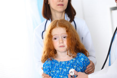 Doctor examining a little girl with stethoscope.Medicine and healthcare conceptの写真素材