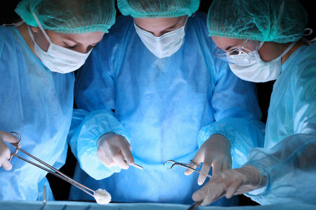 Group of surgeons in masks performing operation. Medicine, surgery and emergency help conceptsの写真素材