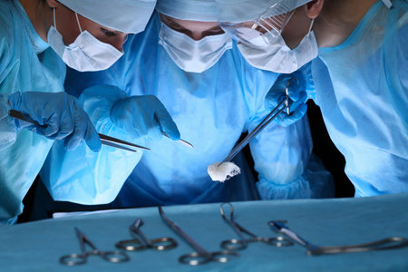 Group of surgeons in masks performing operation. Medicine, surgery and emergency help concepts