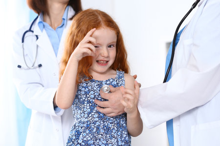 Doctor examining a little girl with stethoscope.Medicine and healthcare conceptの写真素材