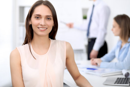 Portrait of a young business woman  at meeting. Negotiation conceptの写真素材