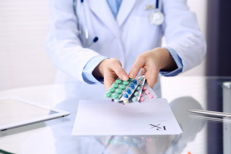 Unknown doctor hands holding pack of different tablet blisters closeup. Life save service, legal drug store, prescribe medication, disease healing conceptの写真素材