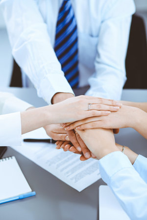 Business people group joining hands and representing concept of friendship and teamworkの写真素材
