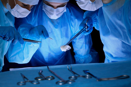 Group of surgeons in masks performing operation. Medicine, surgery and emergency help concepts.