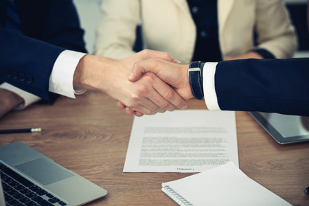 Business people shaking hands at meeting or negotiation in the office. Handshake concept. Partners are satisfied because signing contract.の写真素材