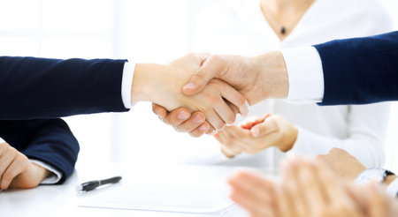 Business people shaking hands finishing up a meeting , close-up. Success at negotiation and handshake concepts. Group of lawyers at workの写真素材