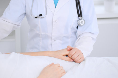 Female doctor holding application form while consulting patient.の写真素材