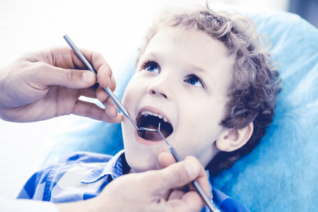 Doctor and patient child. Boy having his teeth examined with dentist. Medicine, health care and stomatology conceptの写真素材