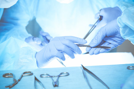 Close-up of medical team performing operation. Group of surgeons at work are busy of patient. Medicine, veterinary or healthcare and emergency in hospitalの写真素材
