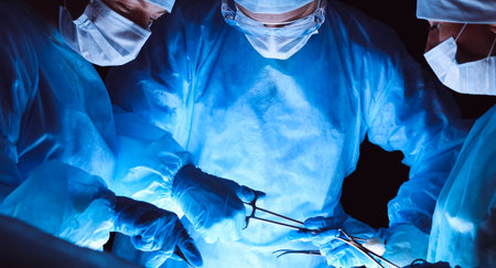 Group of surgeons wearing safety masks performing operation. Medicine conceptの写真素材