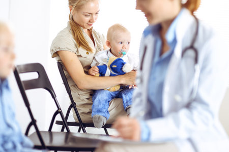Happy smiling child patient at usual medical inspection. Doctor and patient in clinic. Medicine, healthcare conceptsの写真素材