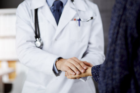 Friendly red-beard doctor reassuring his female patient. Medical ethics and trust concept, medicine themeの写真素材