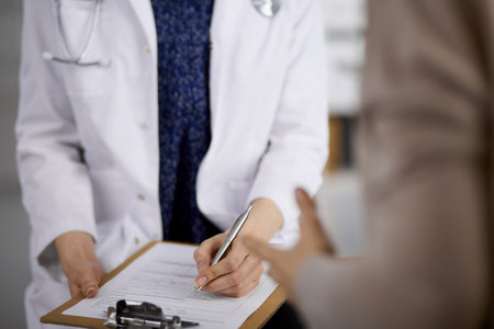 Doctor and patient discussing current health examination while sitting in clinic. Perfect medical service in hospital. Medicine conceptの写真素材