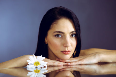 Portrait of smiling brunette woman looking at camera. Beauty concept