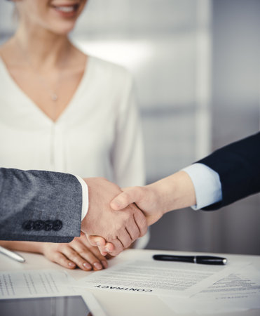 Business people shaking hands finishing contract signing, close-up. Business communication concept. Handshake and marketingの写真素材