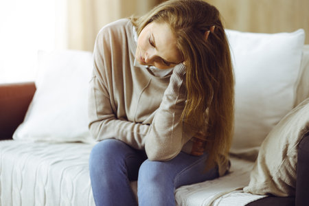 Tired upset woman worried about tiredness from domestic work and self isolation quarantineの写真素材