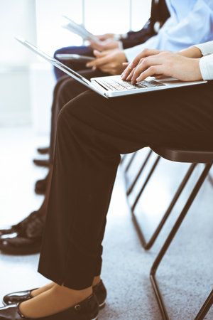 Group of business people working in office, close-up. Businesswoman typing on laptop. Conference, training or meeting conceptsの写真素材