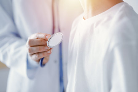 Unknown doctor and kid boy patient at usual medical inspection. Physician works using stethoscope, close up. Medicine, healthcare conceptsの写真素材