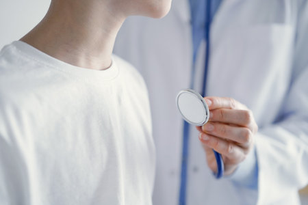 Unknown doctor and kid boy patient at usual medical inspection. Physician works using stethoscope, close up. Medicine, healthcare conceptsの写真素材