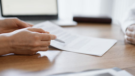 Businesswoman lawyer pointing into contract special points admitting something for colleague or...