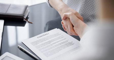 Business people signing contract papers while sitting at the glass table in office, closeup....