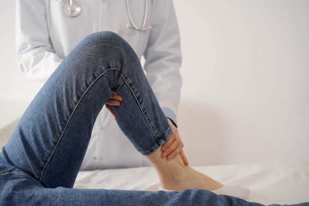 Doctor and patient are at the usual medical inspection in the clinic. Therapist examines a young...