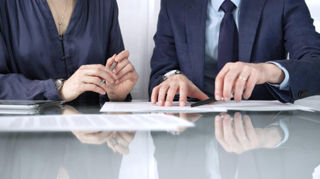 Business partners or lawyers are reviewing contract terms during a meeting, negotiating and making decisions together. Business people concept, close up viewの写真素材