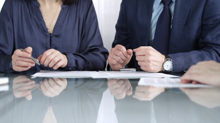 Business partners or lawyers are reviewing contract terms during a meeting, negotiating and making decisions together. Business people concept, close up viewの写真素材