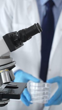 Microscope is on a table, ready for innovative medical research in a sterile laboratory environment....