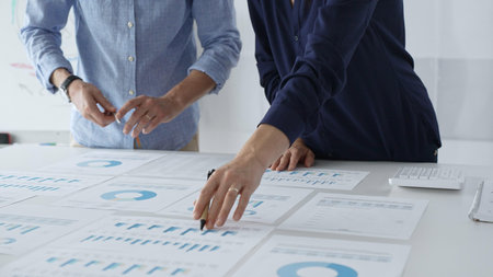 Professional business team analyzing financial reports, sharing insights and planning strategic...