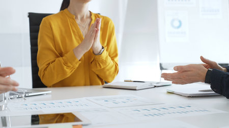 Business colleagues clapping hands after successful presentation or good news during a corporate...